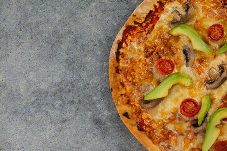 Overhead view of fresh pizza on gray tableの写真素材