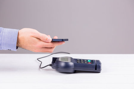 Man using smartphone to express pay