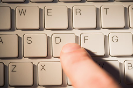 Finger pressing d key on keyboardの写真素材