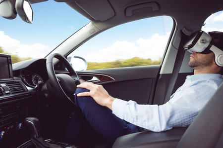 man behind the wheel wearing a virtual reality helmet