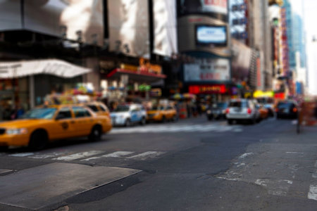 Yellow taxi cab is navigating flat design downtown intersection with zebra crosswalk and billboards. Urban, transportation, modern, commercial, lively, vibrant, cityscapeの写真素材