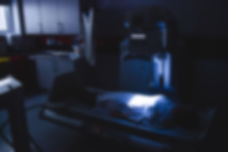 Patient lying under x-ray machine at hospitalの写真素材