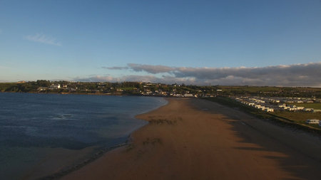 View of beach against sky in townの写真素材