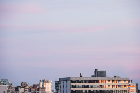 Buildings in city against sky during sunset