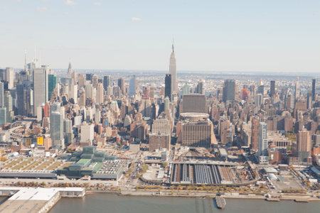 High angle view of cityscape by river against sky on sunny day