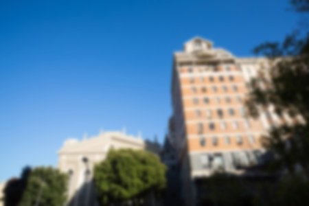 Defocused image of buildings against clear blue sky