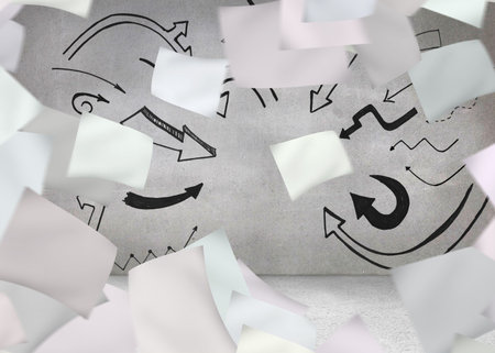 White paper in front of grey wall with arrowsの写真素材