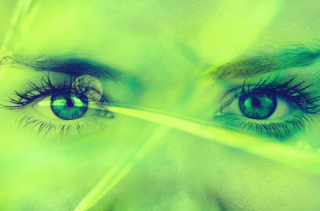 3D render is showing futuristic female face close-up glowing under intense green laser beams. Tech, innovation, cyberpunk, digital, cinematic, holographic, dramaticの写真素材