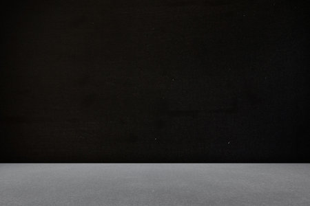 flat design studio scene is featuring smooth grey platform meeting textured black backdrop....