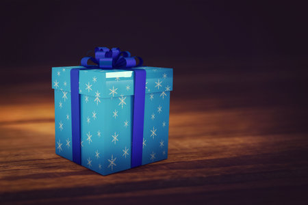 Blue gift box with snowflake-print is sitting on wooden tabletop in 3D render with dark-blue ribbon. Festive, winter, celebration, luxury, decoration, seasonal, eleganceの写真素材