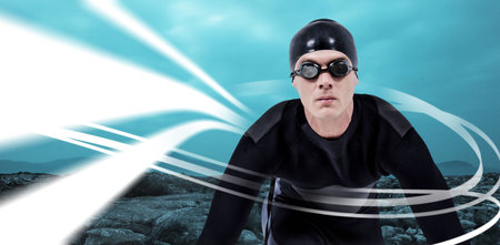 Portrait of swimmer in goggles against digitally generated white lines and rocks