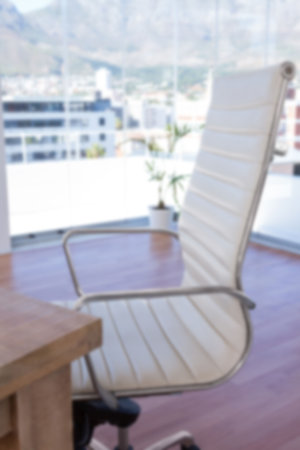 Close-up of office chair by windowの写真素材