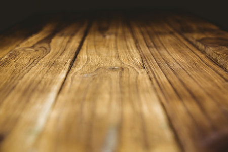 Wooden planks are showing parallel grain patterns and knots in flat design with blurred backdrop. Texture, minimalism, rustic, natural, craftsmanship, interior, detailの写真素材