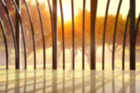 Modern building with glass window against trees during sunsetの写真素材