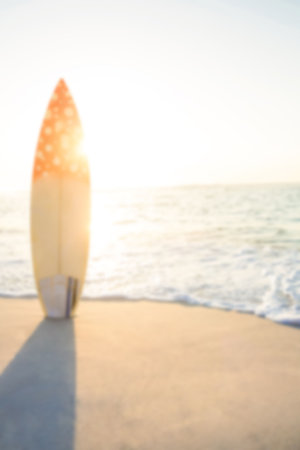 Surfboard on beach against sunny sky