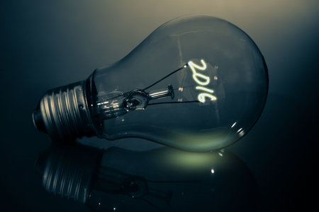 3D render is showing glass incandescent bulb lying on glossy surface filament glowing shaping 2016. Industrial, innovation, technology, illumination, minimalism, futuristic, craftsmanshipの写真素材