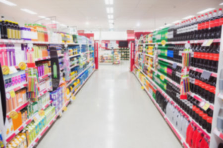 Aisle amidst shelves with products in supermarketの写真素材