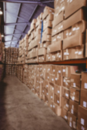 Cardboard boxes arranged in rack in warehouseの写真素材