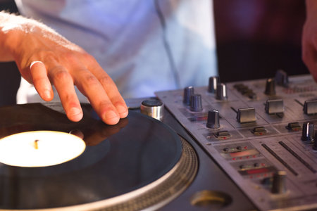Midsection of DJ mixing sound at nightclubの写真素材