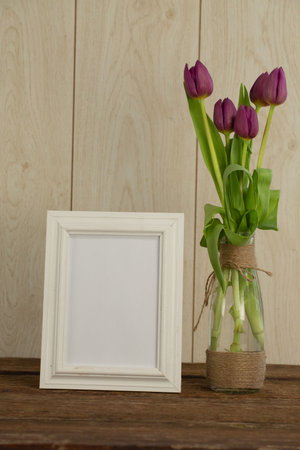 Photo frame and flower vase on table, Close-up