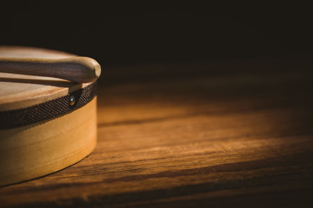 Cropped stick on bodhran over wooden tableの写真素材