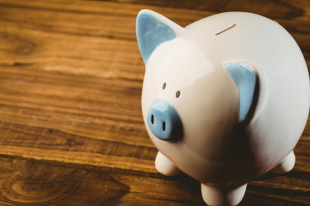 High angle view of piggy bank over wooden tableの写真素材