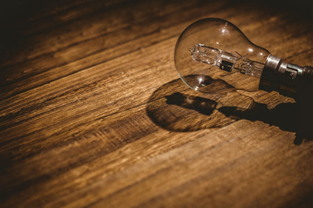 High angle view of light bulb on wooden tableの写真素材