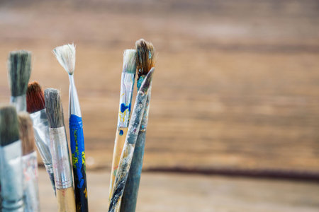 Close-up of paintbrushes on wooden tableの写真素材