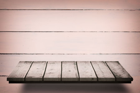 Composite image of wooden shelf on peach wallの写真素材