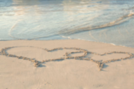 High angle view of heart shape drawing on sand at beachの写真素材
