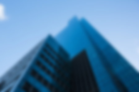 Low angle view of modern towers against sky in cityの写真素材