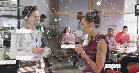 Chatting lanyard-wearing women holding coffee cups in office break area, with circuit board overlay....