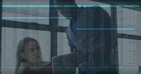 Collaborating office professionals analyzing data on transparent glass panel in meeting room. Corporate, teamwork, modern, innovation, finance, professional, technologyの写真素材