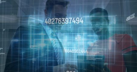 Smiling man in suit viewing smartphone with colleague in red top in lobby, with holographic codes....