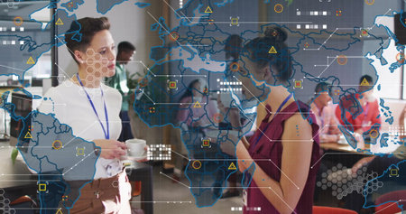 Drinking coffee wearing lanyards two professional women networking in lounge, with data map overlay....