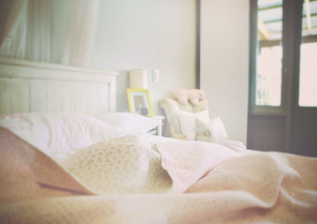Blanket and pillow on bed at homeの写真素材