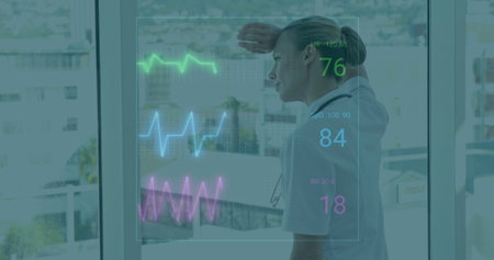 Shielding eyes nurse wearing stethoscope monitoring vitals overlay at hospital window, copy space. Medical, healthcare, digital, analysis, urban, technology, professionalの写真素材