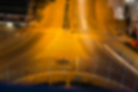 Defocused image of illuminated street at nightの写真素材