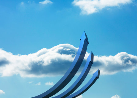 Blue curved arrows pointing up against skyの写真素材