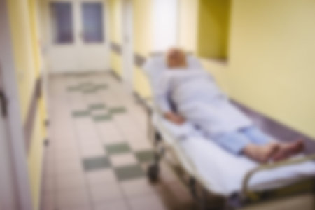 Blurry view of Patient lying on stretcher bed in corridorの写真素材