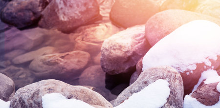 High angle view of rocks covered with snow on streamの写真素材