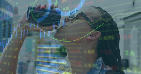 Drinking sunglassed man sipping from tumbler in office, with stock graphs overlay, copy space. Refreshment, productivity, finance, modern, professional, technological, focusedの写真素材