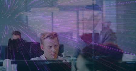 Collaborating modern office team reviewing monitors at workstations, purple light overlay....