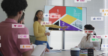 Pointing businesswoman presenting infographic slides on screen in conference room, with notebooks....