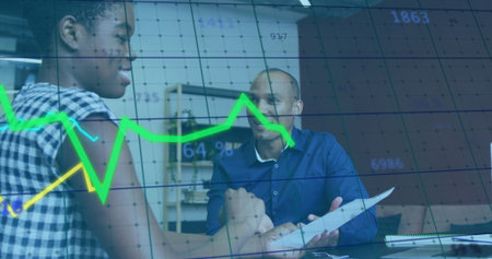Analyzing colleagues in business attire reviewing data in office meeting, with reports and charts. Collaboration, analytics, teamwork, professional, modern, workspace, strategyの写真素材