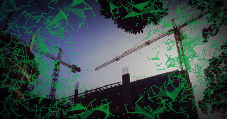 featuring three tower cranes around concrete frame at construction site at dusk, with green overlay....