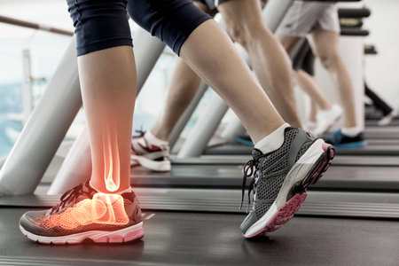 Digital composite of Jogger experiencing ankle painの写真素材
