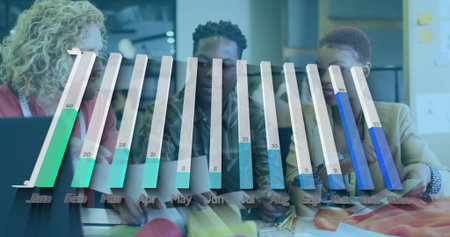 Reviewing three coworkers discussing materials around table in office, with bar chart overlay. Collaboration, brainstorming, data visualization, teamwork, professional, modern, creativeの写真素材