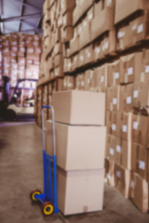 Cardboard boxes on stack barrow in warehouseの写真素材