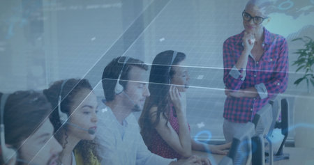 Call center agents wearing headsets focusing on computers in open office, with digital data overlay....
